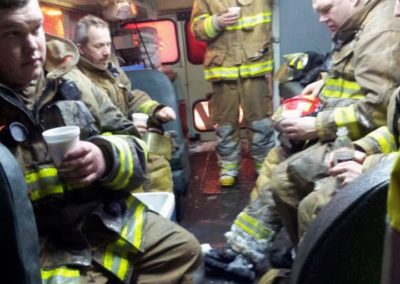 Fire Fighters warm up in converted school bus