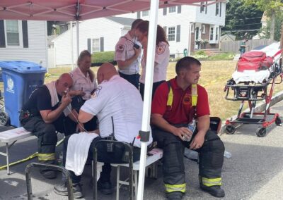 EMTs delivere life-saving services under a Rehab Five tent